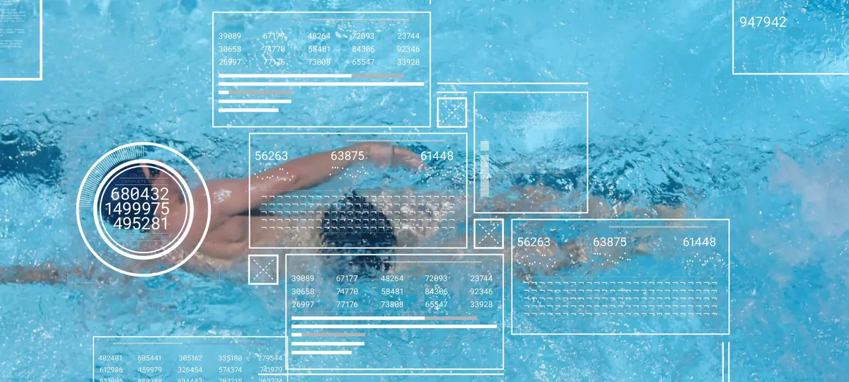Swim coach managing squad workouts and training data on deck