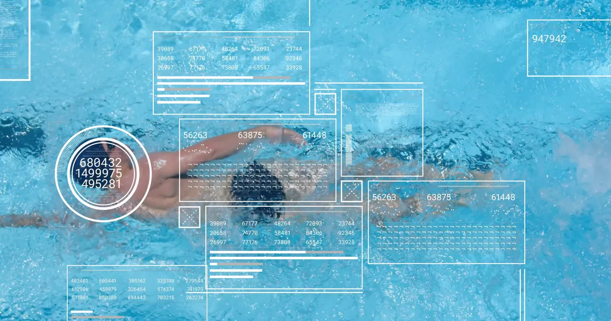 Swim coach managing squad workouts and training data on deck